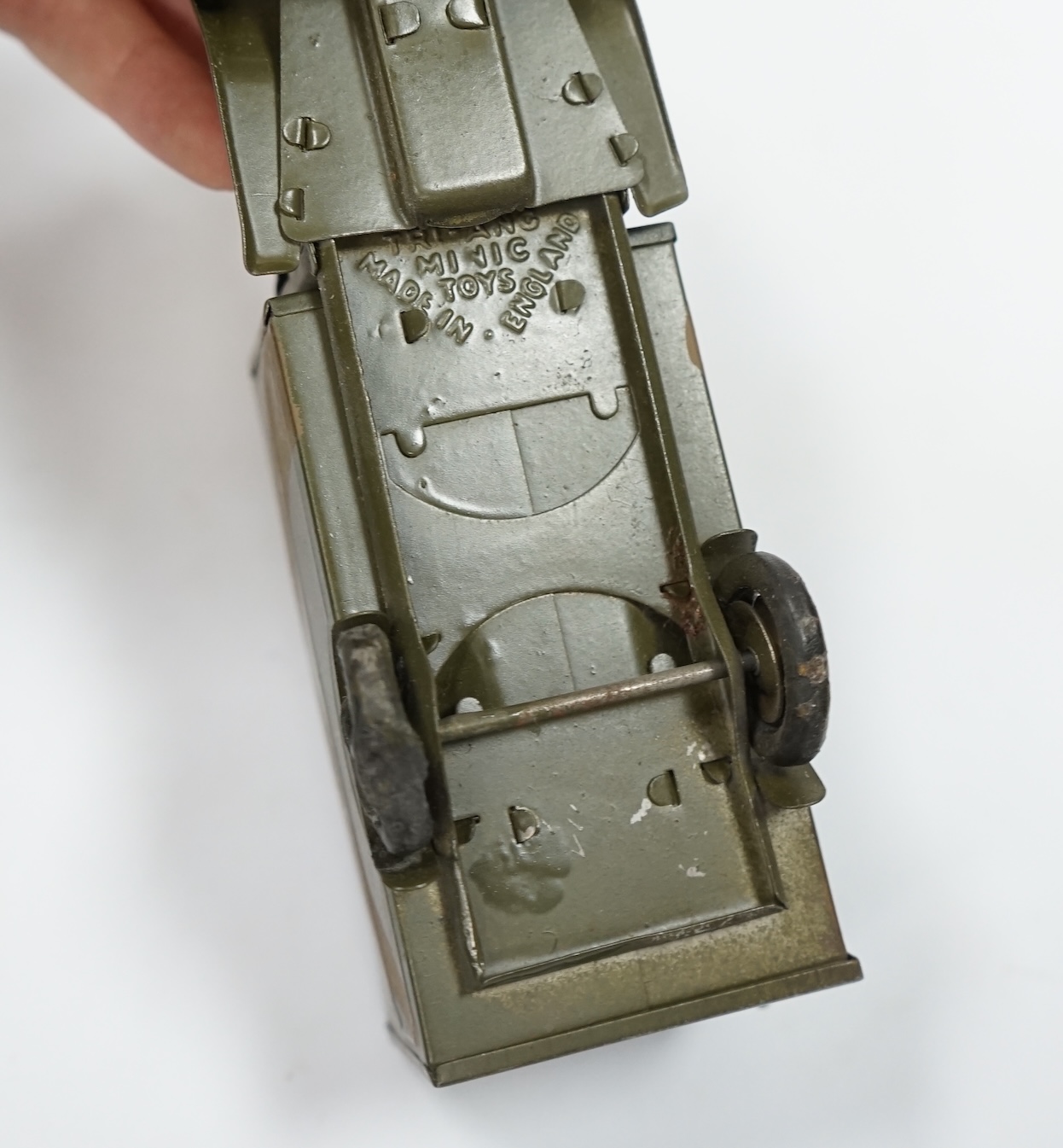 A Tri-ang Minic clockwork tinplate army lorry, in camouflage paint work, together with the remains of its box. Condition fair, original tires fatigued as expected, the box with missing flaps.